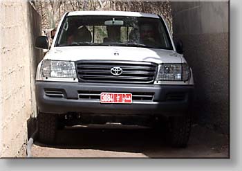 Ya'qoub driving through a narrow lane at Al-Munisifeh