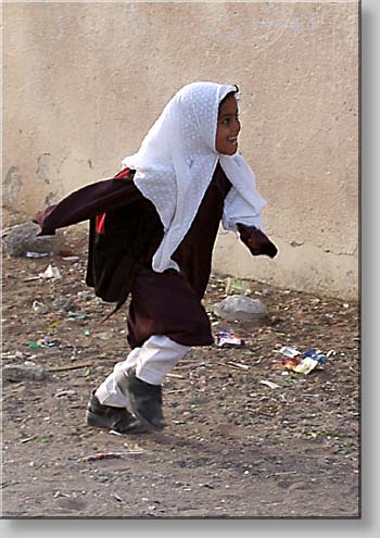 village girl returning from school at Al-Sawadi